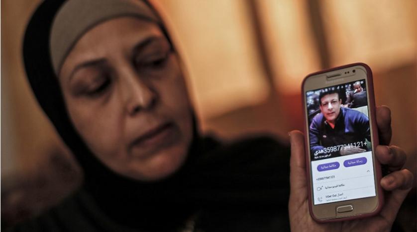 the_sister_of_zaki_mubarak_shows_his_picture_during_an_interview_in_their_family_home_in_deir_al-balah_in_central_gaza_strip_on_april_30_2019._afp.jpg