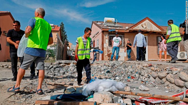 People inspect the damage at a house in the southern Israeli city of Beersheba on Sunday after it was hit in a rocket strike from Gaza.