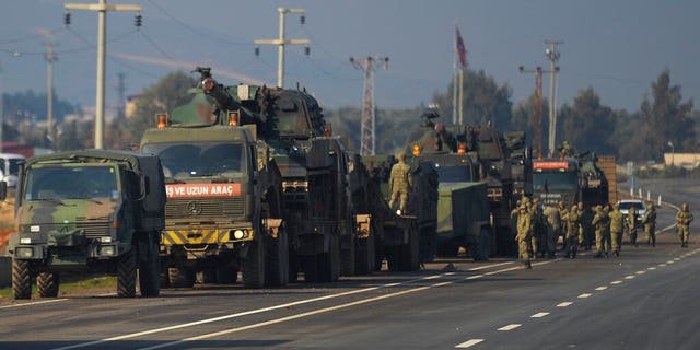 FILE - In this Feb. 14, 2020, file photo, Turkish troops and artillery prepare to enter Syria, in Reyhanli, Hatay, Turkey. (AP Photo, File)