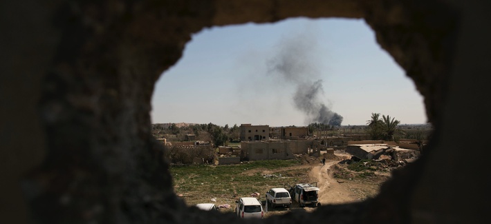 Smoke rises over Islamic State-held Baghouz, the last territory held by the militants in Syria, as U.S.-backed Syrian Democratic Forces (SDF) pound the area with air strikes and artillery on Monday, March 11, 2019.