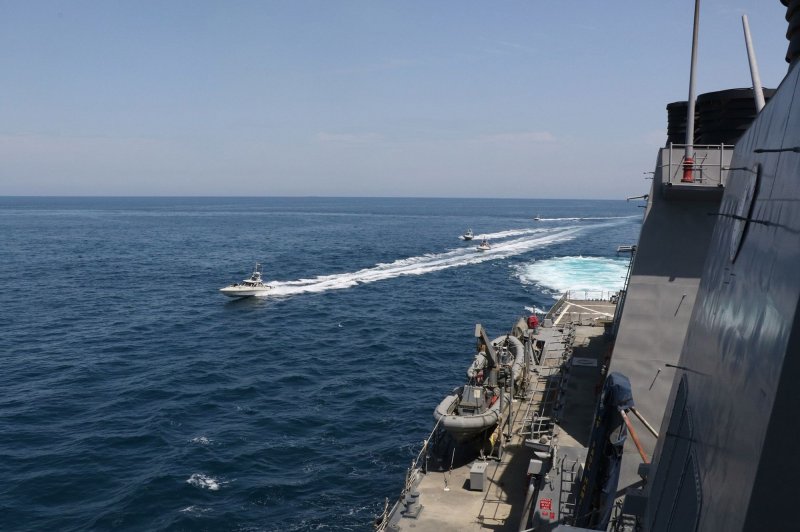 A boat belonging to Iran's Islamic Revolution Guard Corps passes by the USS Hamilton in the North Arabian Gulf on April 15. Photo by U.S. Navy/UPI