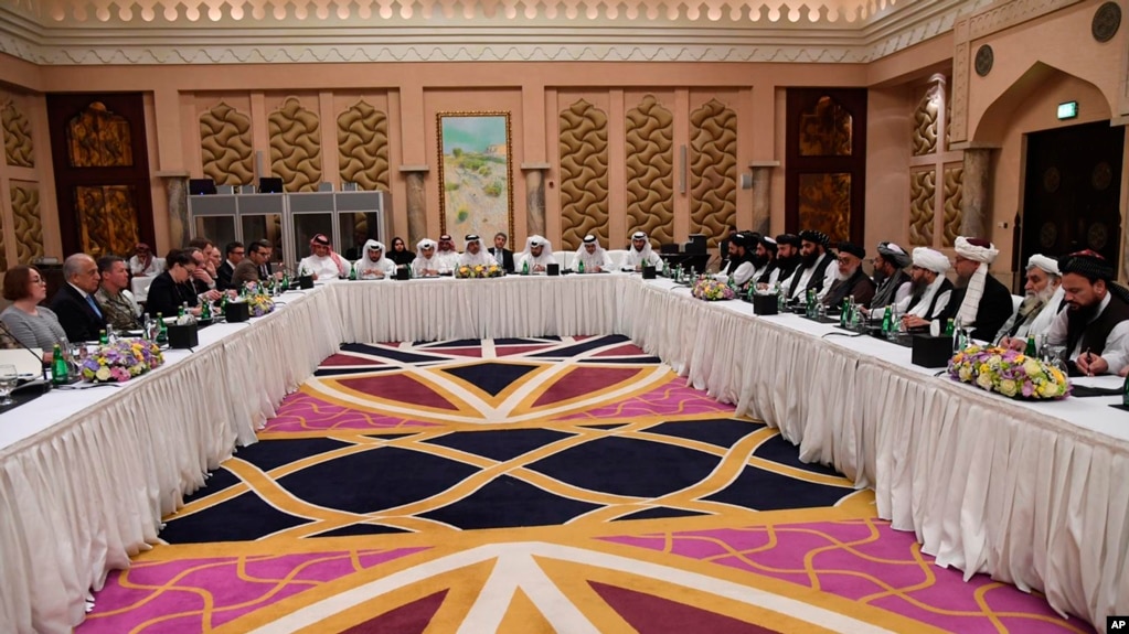 This photo released by Qatar's Ministry of Foreign Affairs shows Qatari, U.S. and Taliban officials holding talks at an undisclosed location, in Doha, Feb. 25, 2019.