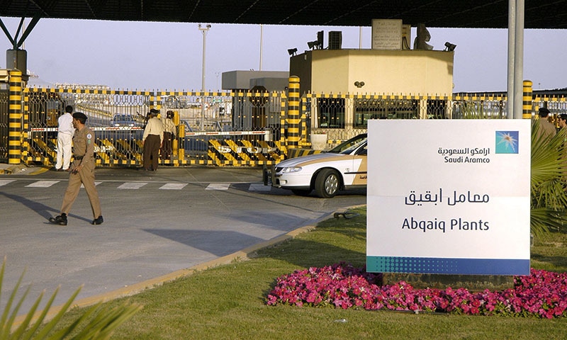 In this file photo taken on February 25, 2006 Saudi security guard the entrance of the oil processing plant of the Saudi state oil giant Aramco in Abqaiq in the oil-rich Eastern Province. — AFP