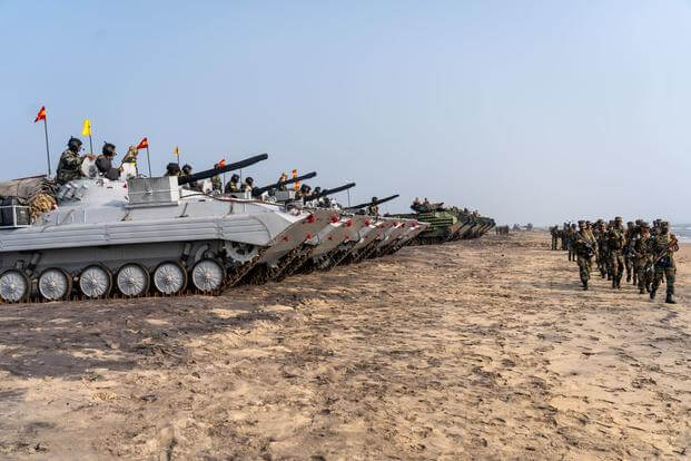 U.S. Marines and Indian soldiers prepare to depart Kakinada, India at the conclusion of exercise Tiger TRIUMPH, Nov. 21, 2019. During Tiger TRIUMPH, U.S. and Indian forces conducted valuable training in humanitarian assistance disaster relief operations by inserting a joint and combined Indian and U.S. force from ship-to-shore in response to a hypothetical natural disaster. While on shore, the forces conducted limited patrolling, moved simulated victims to medical care and produced and distributed drinking 