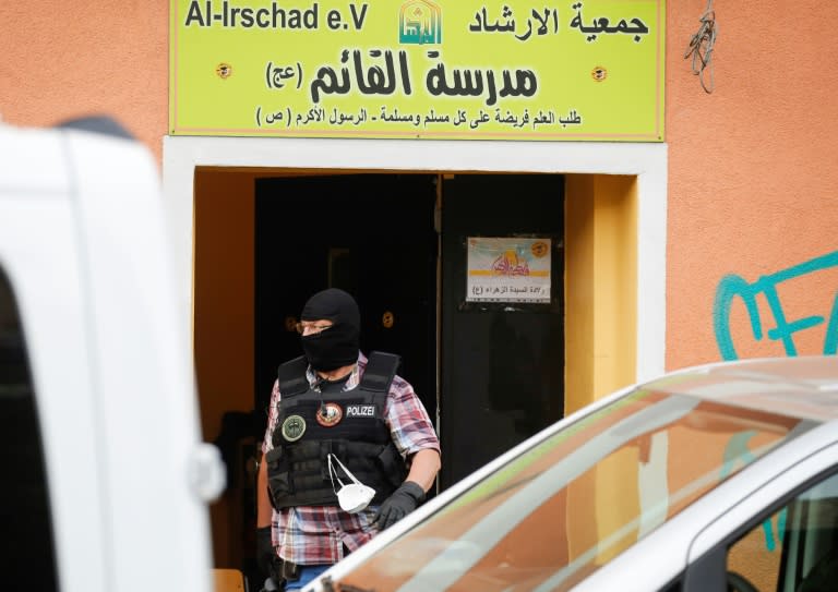 A police officer walks out of Al-Irschad Mosque during a raid in Berlin, as dozens of police and special forces stormed mosques and associations linked to Hezbollah in Bremen, Berlin, Dortmund and Muenster early Thursday. (AFP Photo/Odd ANDERSEN)