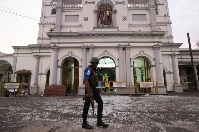 A soldier walks in front of St. Anthony’s Shrine in Colombo on April 26, 2019. Authorities on April 25 lowered the death toll in a spate of Easter bombings by more than 100 to 253, admitting some of the badly mutilated bodies had been erroneously double-counted.